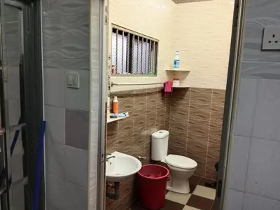 a small bathroom with a toilet and a sink at Krishna Villa in Simpang
