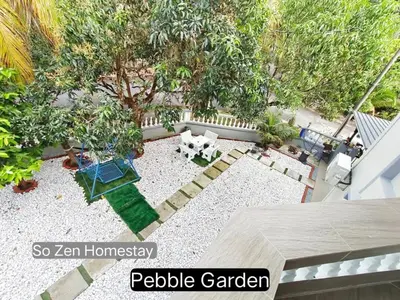 an aerial view of a patio with a dog in a garden at So Zen Homestay in Taiping