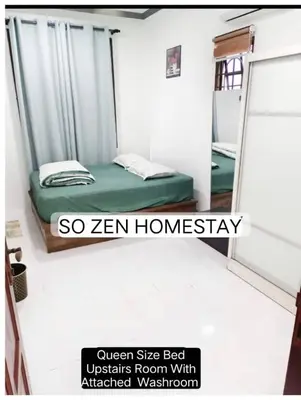a small room with a bed and a mirror at So Zen Homestay in Taiping