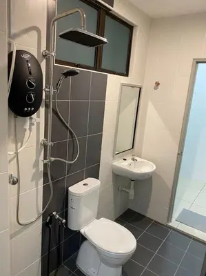 a bathroom with a shower and a toilet and a sink at Chicken Little 4-bedroom home with free parking! Available for Business Trip in Kampong Lima Kongsi