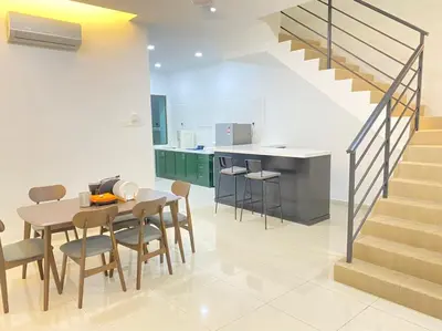 a kitchen and dining room with a table and a staircase at Chicken Little 4-bedroom home with free parking! Available for Business Trip in Kampong Lima Kongsi