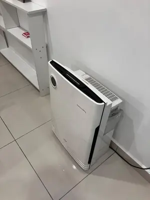 a white appliance sitting on the floor in a kitchen at Chicken Little 4-bedroom home with free parking! Available for Business Trip in Kampong Lima Kongsi
