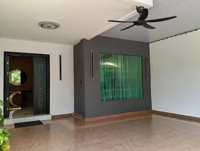 a living room with a ceiling fan and a door at Luxurious Noble Homestay in Sungai Petani