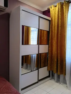 a dresser with a mirror in a bedroom at Luxurious Noble Homestay in Sungai Petani