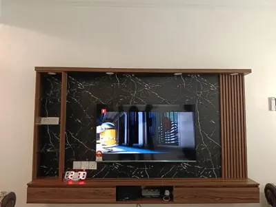 a flat screen tv sitting on top of a entertainment center at Luxurious Noble Homestay in Sungai Petani