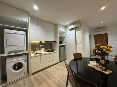 a kitchen and dining room with a table and a washing machine at Joyful Seaview Studio 118 Island88 for 3pax in George Town