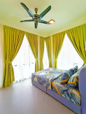 a bedroom with a bed and a ceiling fan at Cahaya homestay Penthouse Cameron Highlands in Brinchang