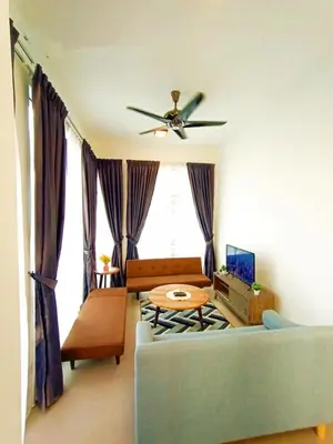 a living room with a couch and a ceiling fan at Cahaya homestay Penthouse Cameron Highlands in Brinchang
