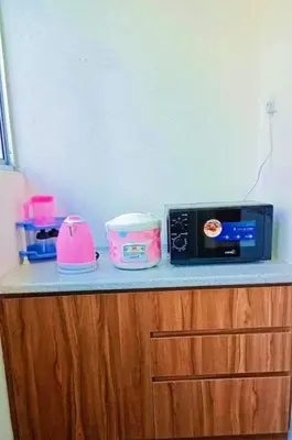 a counter with a microwave and other kitchen items on it at Cahaya homestay Penthouse Cameron Highlands in Brinchang