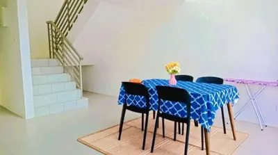 a blue table with black chairs and a blue table cloth at Cahaya homestay Penthouse Cameron Highlands in Brinchang