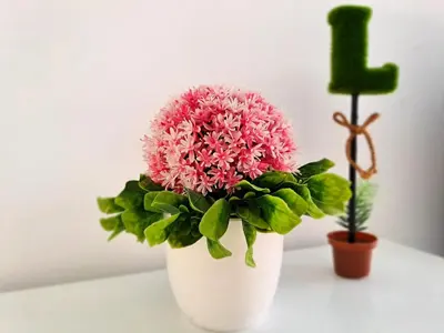 a pink flower in a white vase on a table at Lunas Kulim Hi Tech BKE Q Comfort in Kubang Semang