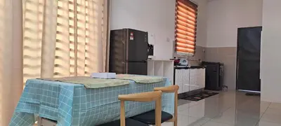 a kitchen with a table and a refrigerator at Lunas Kulim Hi Tech BKE Q Comfort in Kubang Semang