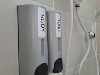 a white and black object hanging on a wall at Lunas Kulim Hi Tech BKE Q Comfort in Kubang Semang