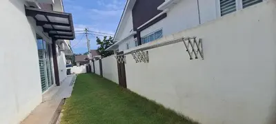 an alley with a white building with a grass yard at Lunas Kulim Hi Tech BKE Q Comfort in Kubang Semang