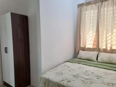 a bedroom with a bed and a window at Lunas Kulim Hi Tech BKE Q Comfort in Kubang Semang