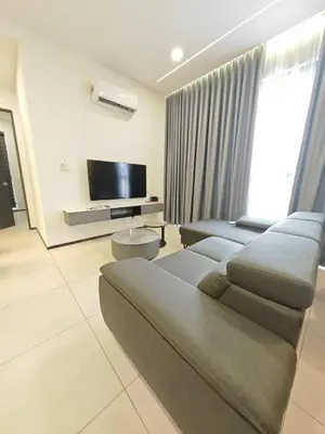a living room with a couch and a flat screen tv at Penang Urban Homestay in Jelutong