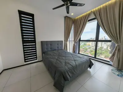 a bedroom with a bed and large windows at Penang Urban Homestay in Jelutong
