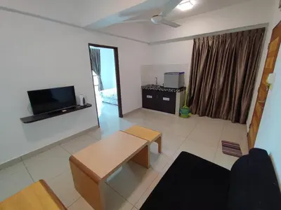 a living room with a couch and a table in it at 3B2BR Marina Height Family Room Sea View Room in Lumut