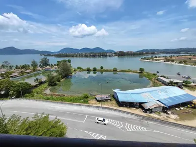 a large body of water with a building and a road at 3B2BR Marina Height Family Room Sea View Room in Lumut