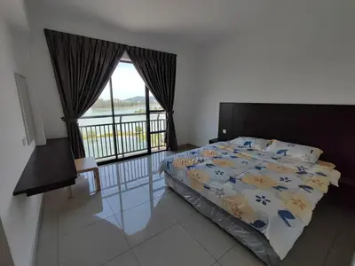 a bedroom with a bed and a large window at 3B2BR Marina Height Family Room Sea View Room in Lumut