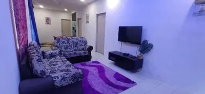 a living room with a couch and a tv at River Truss Homestay in Nibung Tebal