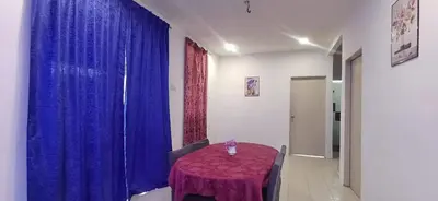 a dining room with a purple table and blue curtains at River Truss Homestay in Nibung Tebal