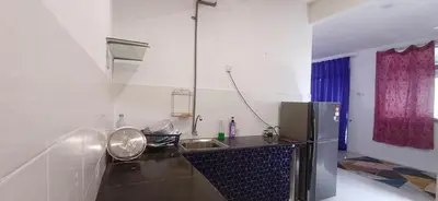 a kitchen with a sink and a refrigerator at River Truss Homestay in Nibung Tebal