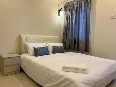 a bedroom with a white bed with a window at Omari 2 Marina Island Homestay Lumut in Lumut