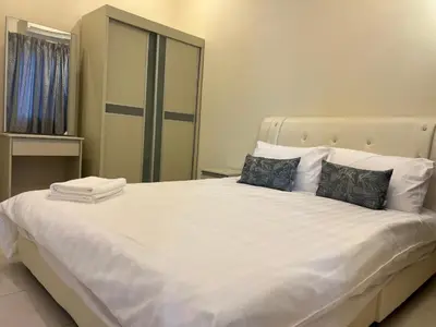 a bedroom with a large white bed with a mirror at Omari 2 Marina Island Homestay Lumut in Lumut