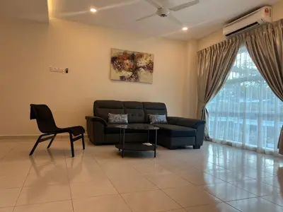 a living room with a couch and a table at Omari 2 Marina Island Homestay Lumut in Lumut