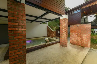 a swimming pool in the middle of a house at The HIJAU Camp & Cabin in Gopeng