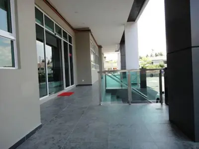 an empty hallway of a building with glass doors at Galaxy Hotel SIMPANG AMPAT in Simpang Ampat
