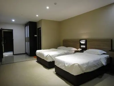 a hotel room with two beds in a room at Galaxy Hotel SIMPANG AMPAT in Simpang Ampat