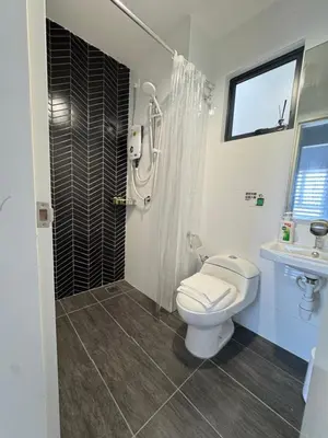 a bathroom with a shower and a toilet and a sink at The Horizon - Ipoh' Rachel in Ipoh