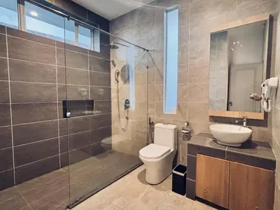 a bathroom with a toilet and a sink and a shower at Regent Event & Leisure in Ipoh