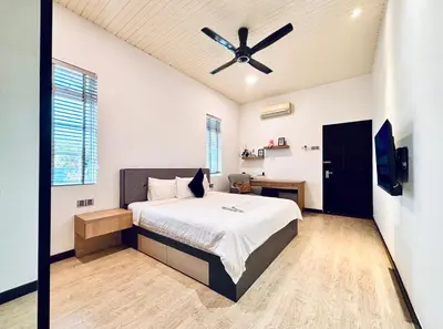 a bedroom with a bed and a ceiling fan at Regent Event & Leisure in Ipoh
