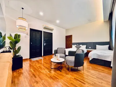 a bedroom with a bed and a couch and a table at Regent Event & Leisure in Ipoh