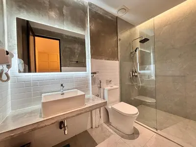 a bathroom with a sink and a toilet and a shower at Regent Event & Leisure in Ipoh