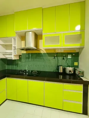 a kitchen with bright yellow cabinets and black counter tops at D'Cozy Homestay in Seri Manjung