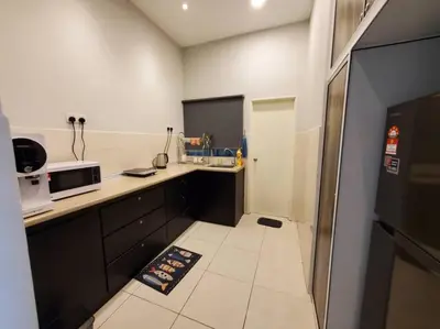 a small kitchen with a counter and a microwave at Sekinchan Kent's House with wide paddy view in Sekincan