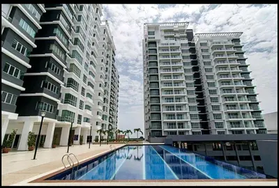 two tall buildings with a swimming pool in front of them at Sekinchan Kent's House with wide paddy view in Sekincan