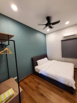 a bedroom with a bed and a ceiling fan at Sekinchan Kent's House with wide paddy view in Sekincan