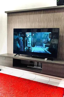 a large flat screen tv sitting on a entertainment center at Md Homestay in Kampong Kubang Menderong