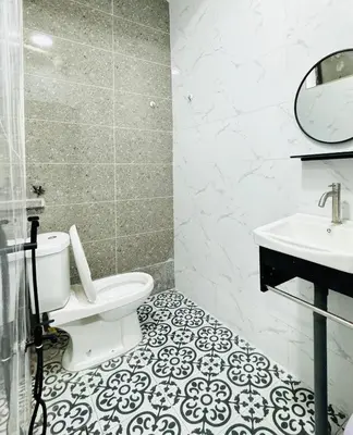 a bathroom with a toilet and a sink at Warisan Guest House Ipoh in Ipoh