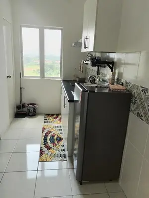 a kitchen with a sink and a counter top at Al Qarni Homestay in Ipoh