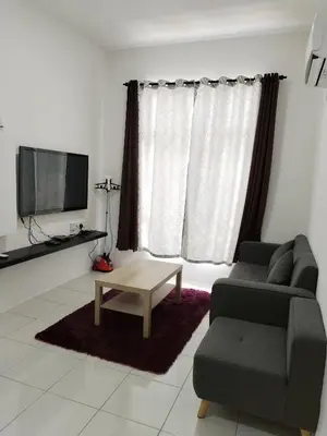 a living room with a couch and a coffee table at Al Qarni Homestay in Ipoh