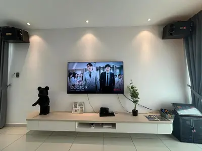 a living room with a tv on a wall at Ipoh Lahat Mines Private Pool Lake Villa by IWH Suites in Lahat