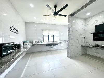 a large white kitchen with a ceiling fan at Ipoh Lahat Mines Private Pool Lake Villa by IWH Suites in Lahat