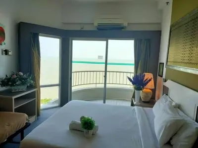 a bedroom with a bed with a view of the ocean at Seaview appointment 3 bedroom in Tanjung Bungah