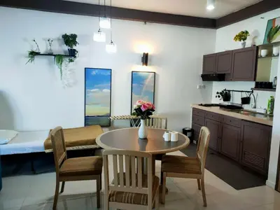 a kitchen and dining room with a table and chairs at Seaview appointment 3 bedroom in Tanjung Bungah